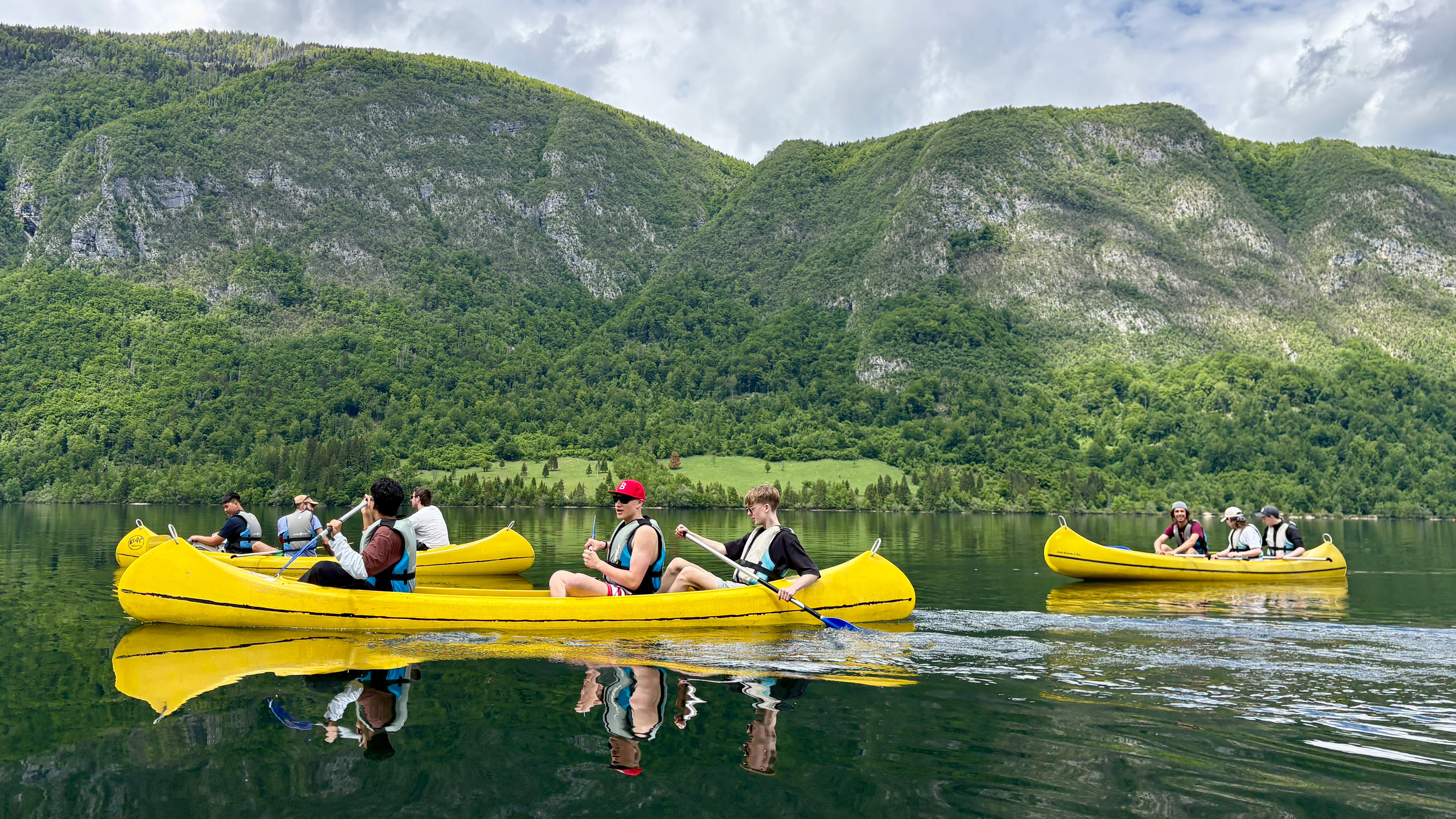 Students on a boat ride on a crystal clear lake in Slovenia